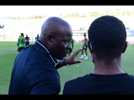 Assistant Coach Marcel Gayle and Head Coach Paul Hall (left) in dialogue ahead of the Jamaica vs El Salvador World Cup Qualifier  at the National Stadium, St Andrew on Thursday, March 24, 2022.
