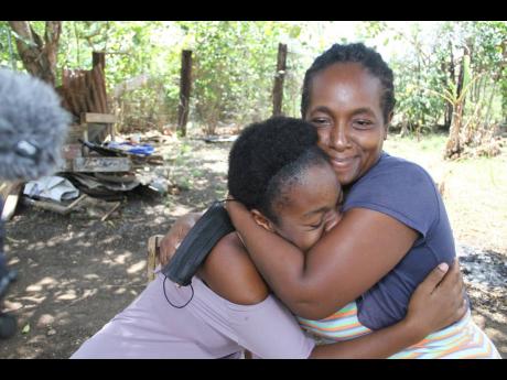 Lison Johnson embraces her daughter, 17-year-old Tehanna Williams, during an emotional interview with The Gleaner.
