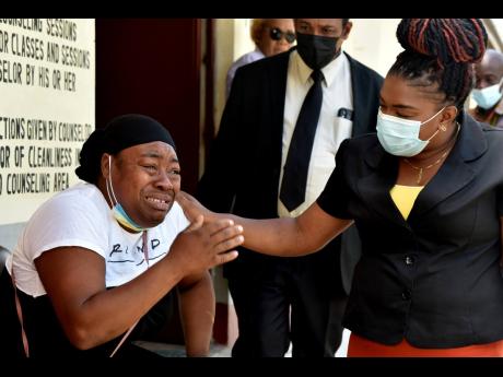 Sherry-Ann Williams is overcome with emotion as she recalls how her cousin, 13-year-old Omarion Haniford, was allegedly stabbed to death by his uncle. Williams is seen here being comforted by Jacquane Crossett, a guidance counsellor. 