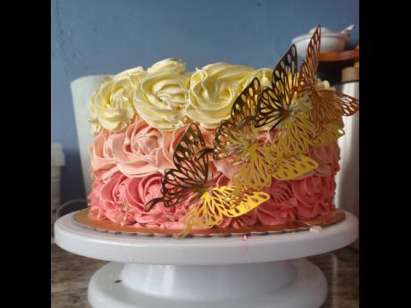 A stunning pink and white rosette cake personalised with gold butterflies. 