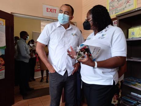 Minister of Health and Wellness Dr Christopher Tufton and Dr Yasine Hanna at the Men’s Health Clinic at the Mile Gully Health Centre on Wednesday. 