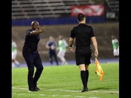 Jamaica’s head coach Paul Hall (left) reacts to a play on the pitch during Wednesday night’s Concacaf World Cup qualifying match against Honduras at the National Stadium. Jamaica won 2-1. 