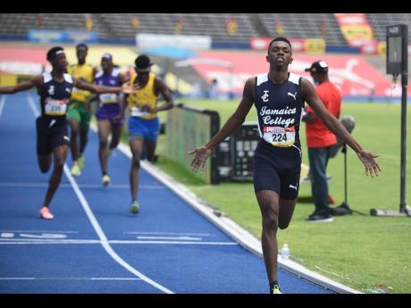 
Jamaica College’s Kemarrio Bygrave (right) and his teammate Khandale Frue (left) celebrate after finishing first and second respectively in the ISSA/GraceKennedy Boys’ and Girls’ Championships class two 800 metres final at the National Stadium last 