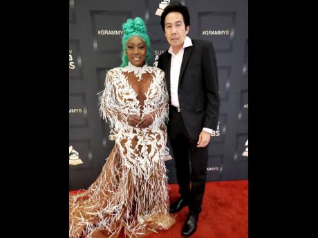 Queen of the Dancehall, Spice, looking regal on the red carpet at the 64th Grammy Awards at the MGM Grand Garden Arena in Las Vegas on Sunday. Accompanying her is President of VP Records, Chris Chin. Spice’s Grammy nominated, debut album, ‘10’, was r