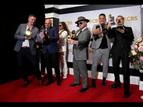 Soja, winners of the award for best reggae album for ‘Beauty in the Silence’, pose in the press room at the 64th Annual Grammy Awards at the MGM Grand Garden Arena last Sunday.