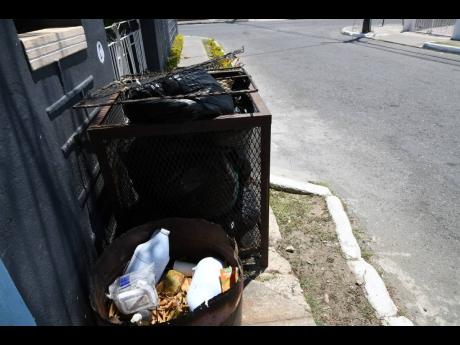 Garbage bins waiting to be emptied in Independence City, Portmore.