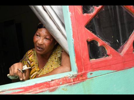 Evanie Henry, common-law widow of Donald ‘Tabby Diamond’ Shaw, in tears at the home of the late reggae singer on Wednesday.