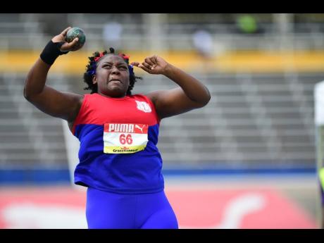 Camperdown High School’s Victoria Christie on her way to a winning throw in the girls’ Class Two shot put at the ISSA/GraceKennedy Boys and Girls’ Athletics Championships inside the National Stadium yesterday.