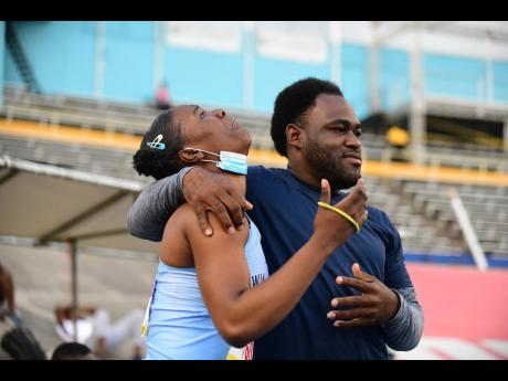 Monifa Edwards of Edwin Allen High cries tears of joy as she celebrates her second place finish in the javelin open with coach Romaine Thompson on day three of the ISSA/GraceKennedy Boys and Girls’ Championships at the National Stadium. 