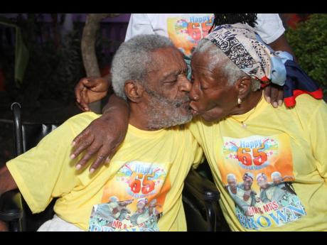 Rudolph and Carol Brown seal 65 years of marriage with a kiss.