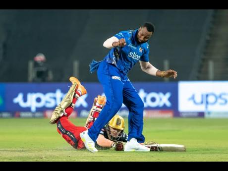 
Mumbai Indians’ Kieron Pollard attempts a run out during his team’s Indian Premier League contest against the Royal Challengers Bangalore in Pune yesterday.