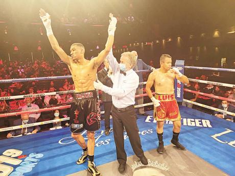 
Referee Yvon Goulet (centre) raises the hand of Jamaican boxer Joshua Frazer (left) who defeated Luis Gonzalez by knockout at 1:57.00 minutes of round one in their fight scheduled for four rounds in Canada at the end of March.