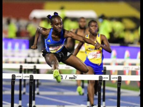 Hydel High’s Kerrica Hill wins her Class Two girls 100 metres hurdles heat in a record 12.89  seconds at the National Stadium on Friday night. 