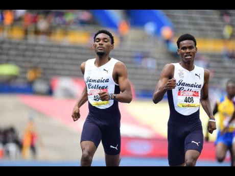 
Jamaica College’s distance duo JVaughn Blake and Handal Roban (left) competing in the boys’ Class One 800 metres at the ISSA/GraceKennedy Boys’ and Girls’ Athletics Championships inside the National Stadium yesterday.