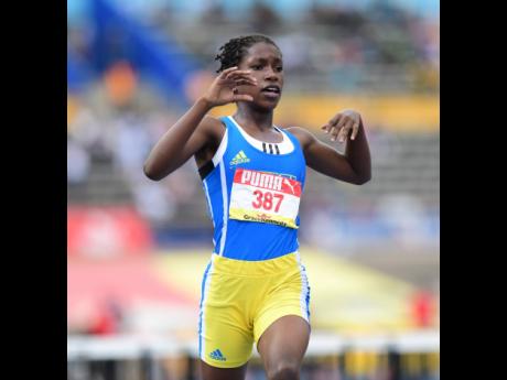 
Hydel’s Malayia Duncan watches the clock just after winning the Class Four girls’ 70-metre hurdles at the ISSA/GraceKennedy Boys and Girls’ Athletics Championships inside the National Stadium yesterday. 