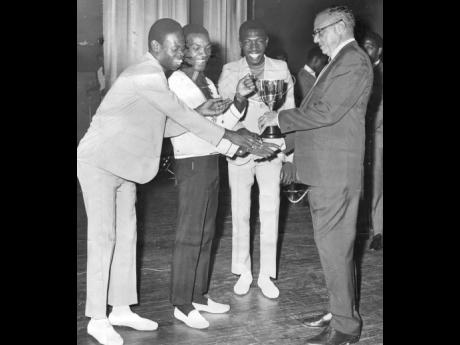 INTENSIFIED FESTIVAL 1968: Desmond Dekker and the Aces, being presented with a D&G cup by Pat Geddes.  This cup is the first of its kind to be presented to Festival Song winners.