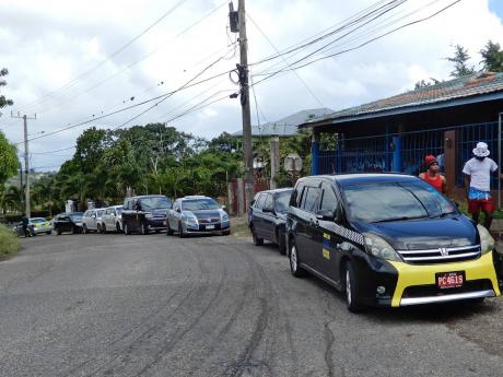 Taxi cabs parked at Dumbarton in St Ann as drivers protested poor road condition on Monday. 