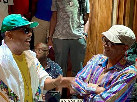 Charlie Wilson makes a point as Beres Hammond listens intently. They were at Harmony House studio in St Andrew last Monday to record their first collaboration.