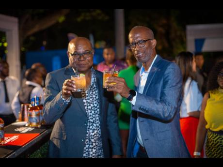  Minister of Tourism Edmund Bartlett (left) and Chair of the Spirits Pool Association Jimmy ‘Clement’ Lawrence raised a toast to the 2022 Jamaica Rum Festival’s launch with Monymusk Plantation Rum cocktails.
