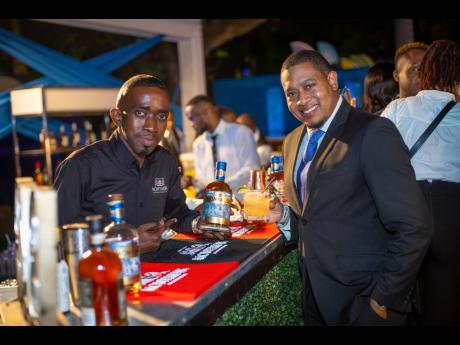 Minister without Portfolio in the Office of the Prime Minister Floyd Green (right) and Monymusk Plantation Rum mixologist Trevor Luke were all smiles as they posed for a picture at the 2022 Jamaica Rum Festival’s launch held at the Formal Gardens of Devo
