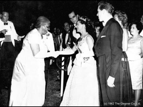
In this 1962 photo Lily Mae Burke, chairman of the Jamaica Federation of Women, is presented to Princess Margaret, by Governor General Sir Kenneth Blackburne (centre) at the King’s House independence reception. At right is the Earl of Snowdon.