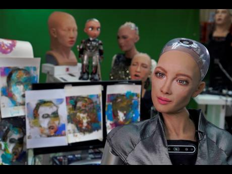 
Sophia answers questions at Hanson Robotics studio in Hong Kong. Sophia is a robot of many talents – she speaks, jokes, sings and even makes art. In March, she caused a stir in the art world when a digital work she created as part of a collaboration was