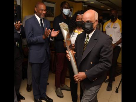 
Christopher Samuda, president of the Jamaica Olympic Association, shows off the Queen’s Baton for the Commonwealth Games 2022, as it arrived in Jamaica from the Cayman Islands during a Baton Receival Ceremony in the VIP Lounge of the Norman Manley Inter