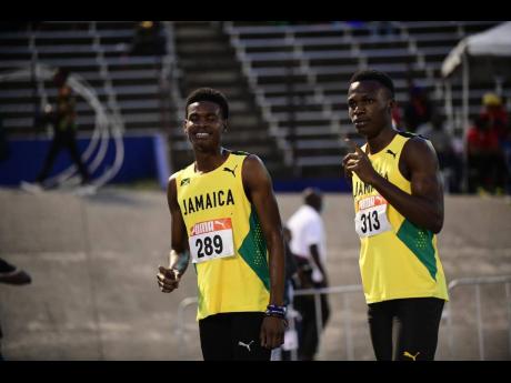 
Jamaica’s J’Voughnn Blake (left) and his teammate Adrian Nethersole pose for cameras after completing a one-two finish in the boys’ under-20 1500 metres at the Carifta Games inside the National Stadium yesterday.