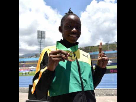 
Wolmer’s Girls’ high jump standout Danielle Noble shows off the gold medal she won in the under-17 high jump competition at the Carifta Games inside the National Stadium yesterday evening.