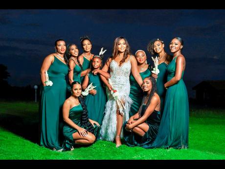 Green was the majestic theme for the women (and girl) of the bridal party. They join the beautiful bride in a supportive picture- perfect moment.