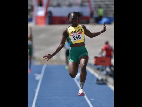 Carifta Games 2022 under-20 long jump gold medallist Serena Cole in action in the pit yesterday at the National Stadium. Cole won the event with a leap of 5.89 metres. 