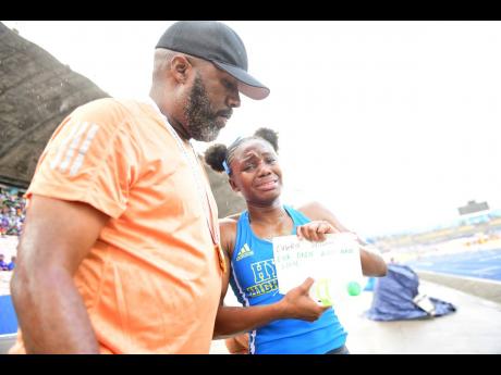 Hydel High School track and field coach, Corey Bennet congratulates an emotional Oneka Wilson after she won the Class One 100-metre hurdles at the recently concluded ISSA/GraceKennedy Boys and Girls’ Athletics Championships.