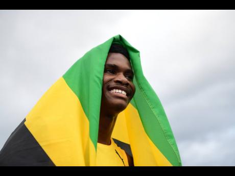 Jamaica’s J’Voughnn Blake is all smiles after winning the Boys’ Under-20 800 metres at the Carifta Games inside the National Stadium on Monday. 