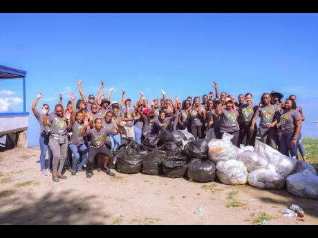 Members of Sandals Resorts International and the Sandals Foundation ahead of Earth Day 2022 engaged in a beach clean-up at Fisherman’s Beach in Montego Bay, St James, on Tuesday.