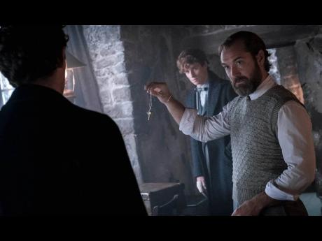 Jude Law (right), as Albus Dumbledore and Eddie Redmayne (centre) as Newt Scamander in ‘Fantastic Beasts: The Secrets of Dumbledore’.