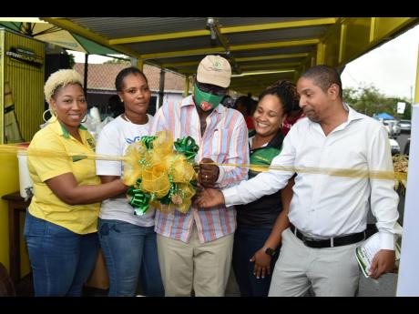 From left: Sasha Warner Campbell, brand manager, domestic and export at J. Wray & Nephew; along with vendor Marsha Walker; Western Kingston Member of Parliament and Local Government Minister Desmond McKenzie; Leleika-Dee Barnes, director of channel and cus
