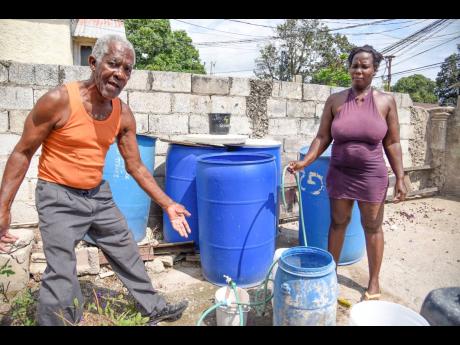 Wesley Gregory (left) and his tenant, Julian Smith, who reside in the Whitfield Avenue area off Maxfield Avenue in Kingston, are crying for the water supply in the area to be improved as they have to source the commodity from truckers at a high rate. Grego