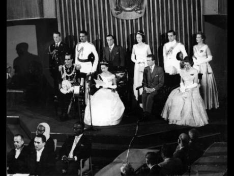 In this August 8, 1962 photo Princess Margaret reads the Queen’s speech with which she declared open Jamaica’s first parliament. On the dais with her are Governor General, Sir Kenneth Blackburne; Earl of Snowdon and Lady Blackburne, with members of the