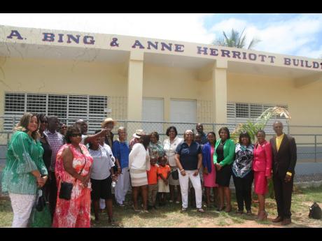 Donors, teachers, students, community members and Ministry of Education and Youth officials pose for a photograph in front of the new Watford Hill Primary and Infant School’s infant department on Thursday, April 21.