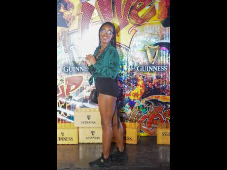 Loving the authentic dancehall vibe at Pan Di Plaza, Tatyana Service shares a smile with our lens. 