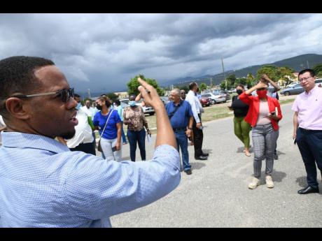 Jason Scott, architect of Design Collaborative International (Jamaica), speaks to bidders during an Urban Development Corporation site visit for the construction of the Houses of Parliament at National Heroes Park in Kingston on Monday. 