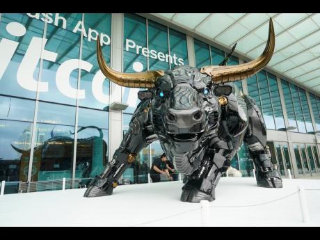 The Miami Bull, a robot-like statue, is unveiled at the Bitcoin 2022 Conference on April 6, 2022 at the Miami Beach Convention Center. It’s meant to emulate Wall Street’s ‘Charging Bull’.