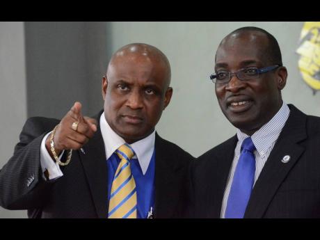 Professor Fritz Pinnock (left), who has quit as president of Caribbean Maritime University, is seen here with Ruel Reid. Both men are embroiled in a corruption case.
