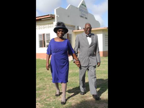 Neville and Jennifer Moodie of Hayse, Clarendon walk in step at their church in Lionel Town.