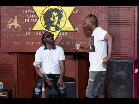 Bounty Killer (left) and Seani B hod a reasoning at Tuff Gong as the Gong himself looks on.