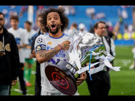 
Real Madrid’s Marcelo poses with the trophy to celebrate the team’s La Liga title after a Spanish La Liga soccer match between Real Madrid and Espanyol at the Santiago Bernabeu stadium in Madrid yesterday.