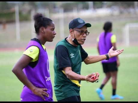 
Reggae Girlz head coach Vin Blaine speaks to a player during a training session at the Stadium East field recently.