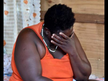 Carneta Edwards is overcome with emotions after her 24-year-old son, Rasheed Edwards, and his friends, 18-year-old Keno Wray and 22-year-old Kevan Jackson, were killed in their Bedward Gardens community in August Town, St Andrew, in a pre-dawn attack yeste