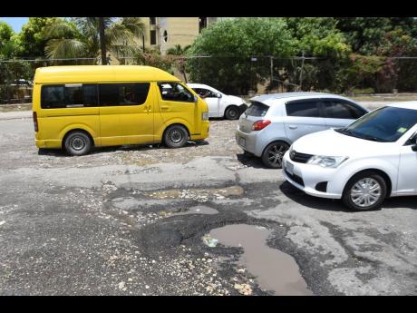 A pothole riddled section of Spanish Town Road near the examination depot.
