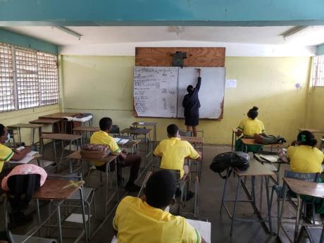 A teacher conducting a lesson at Alston High School in Clarendon. Principal Adrian Sinclair has expressed concern over student apathy at the institution as external exams begin.